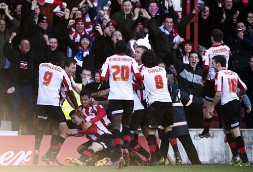 Brentford celebrate with goal-scorer Marcello Trotta at Chelsea at Griffin Park, London, January 27, 2013 Brentford celebrate with goal-scorer Marcello Trotta at Chelsea at Griffin Park, London, January 27, 2013