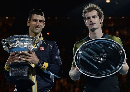 Novak Djokovic (L) holds the winner's trophy after his victory over Andy Murray (R) in Melbourne on January 27, 2013