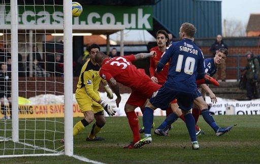 Oldham&#039;s Matt Smith (R) scores against Liverpool in the FA Cup fourth round at Boundary Park on January 27, 2013