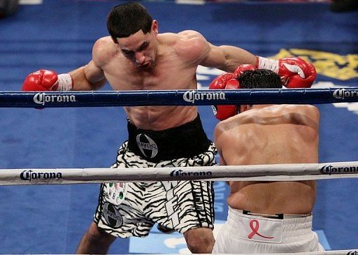 Danny Garcia (L) takes a swing at Erik Morales during their contest in New York on October 20, 2012