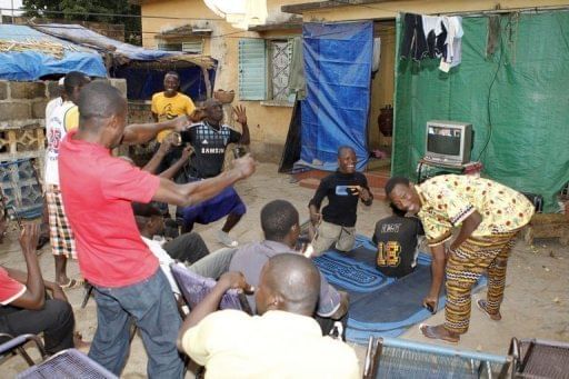 Malian men celebrate in Bamako after Mali scored on January 28, 2013