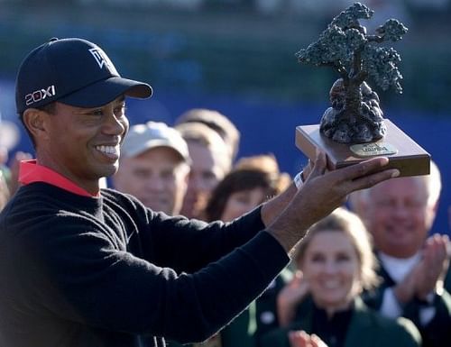 Tiger Woods holds the winner's trophy after victory at the Farmers Insurance Open at Torrey Pines on January 28, 2013