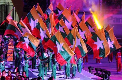 Myanmar&#039;s team members wave during the closing ceremony of the 26th Southeast Asian Games, on November 22, 2011