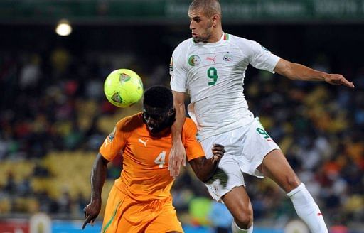 Ivory Coast&#039;s Kolo Toure vies with Algeria&#039;s Islam Slimani in Rustenburg on January 30, 2013