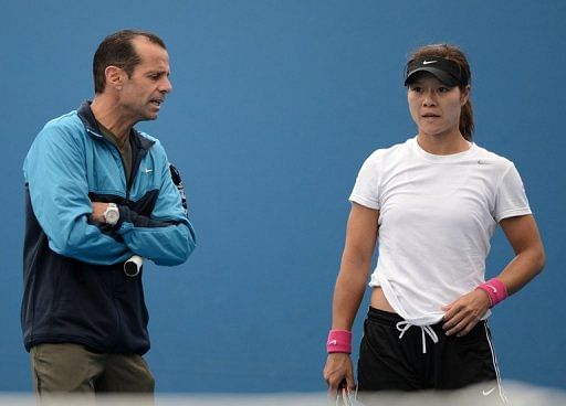 Li Na, pictured with her coach Carlos Rodriguez, during a training session in Melbourne, on January 13, 2013