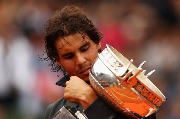 PARIS, FRANCE - JUNE 11:  Rafael Nadal of Spain poses with the Coupe des Mousquetaires trophy in the men&#039;s singles final against Novak Djokovic of Serbia during day 16 of the French Open at Roland Garros on June 11, 2012 in Paris, France.