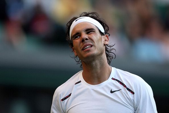 Nadal reacts during his match against Lukas Rosol at Wimbledoon, 2012.