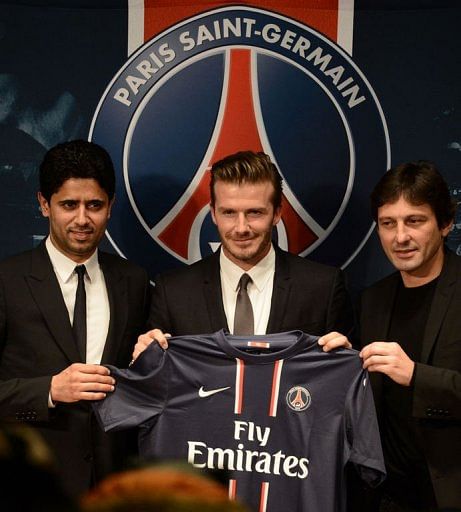 David Beckham (C) poses with his new jersey at the Parc des Princes stadium in Paris, on January 31, 2013