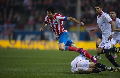 Atletico Madrid&#039;s Brazilian forward Diego Costa (L) is fouled in Madrid on January 31, 2013