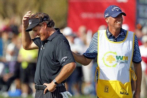 Phil Mickelson is consoled after missing his birdie putt on the 9th hole during the first round January 31, 2013