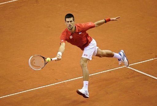 Serbia&#039;s Novak Djokovic returns a ball to Belgium&#039;s Olivier Rochus on February 1, 2013