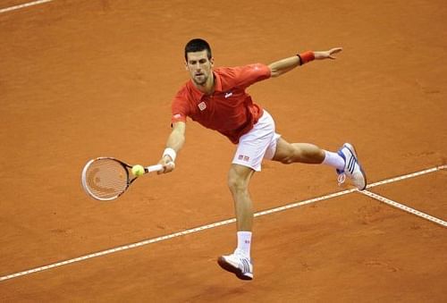 Serbia's Novak Djokovic returns a ball to Belgium's Olivier Rochus on February 1, 2013