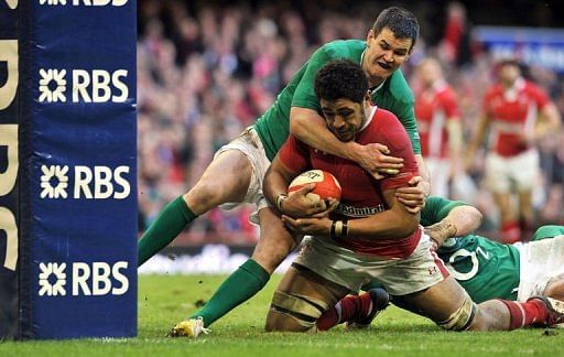 Wales&#039; Toby Faletau is held up on the line by Ireland&#039;s Jonny Sexton (L) in Cardiff on February 2, 2013