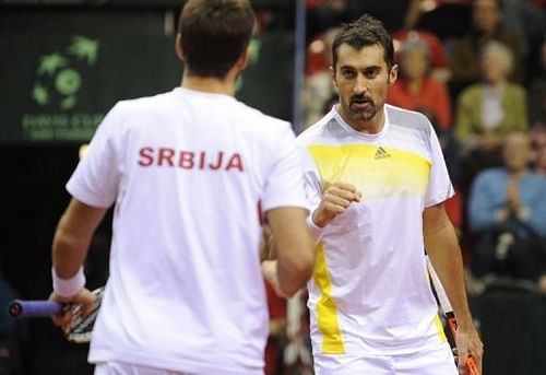 Serbia's Viktor Troicki (L) and Nenad Zimonjic play doubles against Belgium on February 2, 2013 in Charleroi