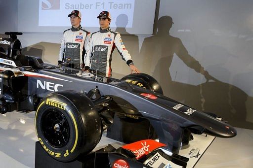 Sauber drivers Nico Hulkenberg (L) and Esteban Gutierrez pose with their Sauber C32-Ferrari race car, February 2, 2013