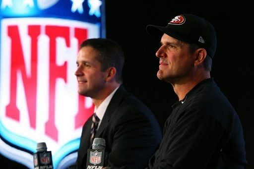 Ravens coach John Harbaugh (L) and 49ers coach Jim Harbaugh at a press conference on February 1, 2013