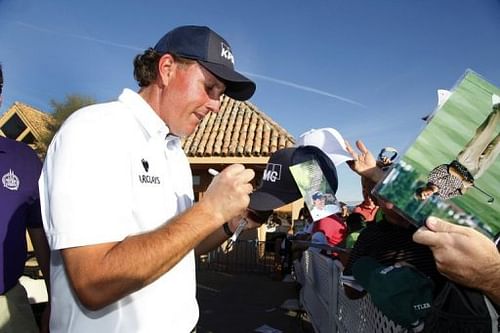 Phil Mickelson autographs a hat for a fan, in Scottsdale in Arizona, on February 2, 2013