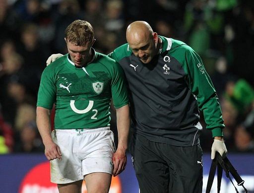 Keith Earls of Ireland (L) is walked from the field injured on June 23, 2012