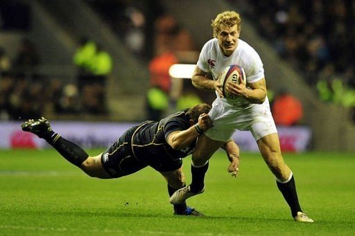 England&#039;s centre Billy Twelvetrees (R) is tackled at Twickenham Stadium, southwest of London on February 2, 2013