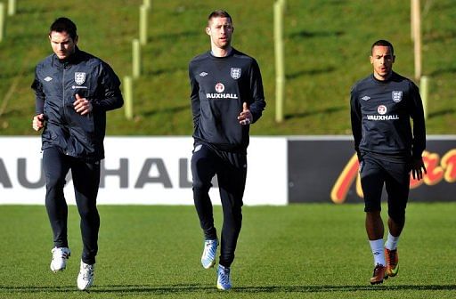 (From L) England's Frank Lampard, Gary Cahill and Theo Walcott, pictured during a training session, on February 4, 2013