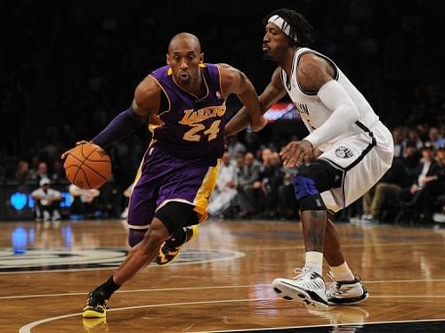 Kobe Bryant drives the ball past Gerald Wallace on February 5, 2013