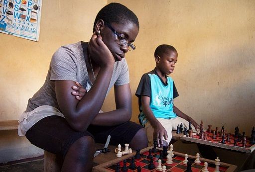 The 16-year old Phiona Mutesi (L) plays chess in Kampala on January 17, 2013