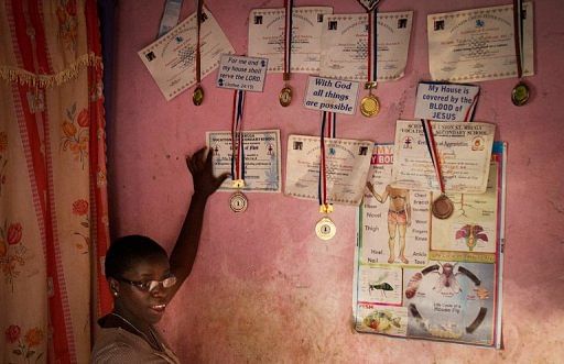 Phiona Mutesi shows off her medals at her home in Kampala on January  17, 2013