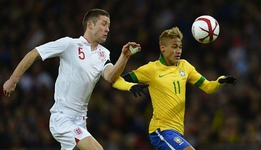 England&#039;s defender Gary Cahill (L) challenges Brazil&#039;s striker Neymar (R) on February 6, 2013