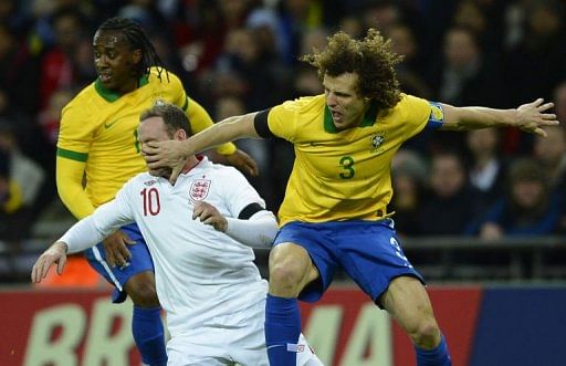 Brazil's defender David Luiz (R) vies with England's striker Wayne Rooney (L) on February 6, 2013