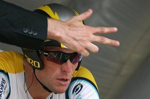 Lance Armstrong listens to the countdown before competing in the Tour de France cycling race on July 23, 2009