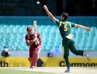 West Indies' Kieron Pollard (L) drives a ball back to Ben Cutting during their ODI match in Sydney on February 8, 2013