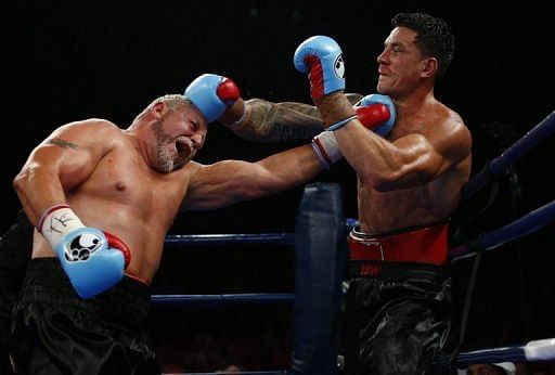 Former All Black Sonny Bill Williams (R) and Frans Botha of South Africa exchange blows in Brisbane on February 8, 2013