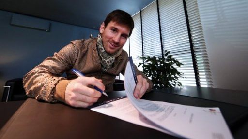 A handout picture taken and released on February 7, 2013 by Barcelona shows Lionel Messi signing his new contract