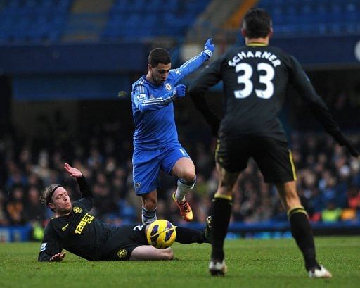 Chelsea&#039;s Eden Hazard (C) jumps a slide tackle from Wigan Athletic&#039;s Ronnie Stam in London on February 9, 2013