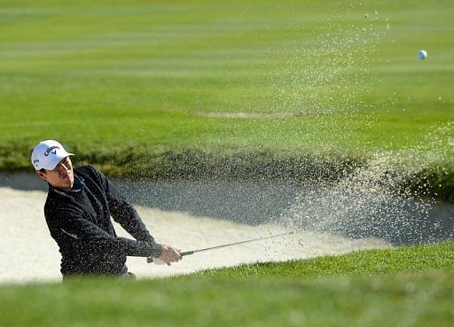 James Hahn hits out of the bunker on the first hole on February 9, 2013 in Pebble Beach, California