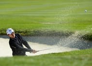 James Hahn hits out of the bunker on the first hole on February 9, 2013 in Pebble Beach, California