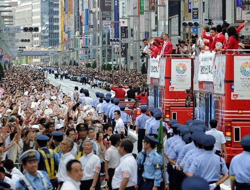 Japan&#039;s medallists from the London Olympics take an open-top bus parade, in Tokyo, on August 20, 2012