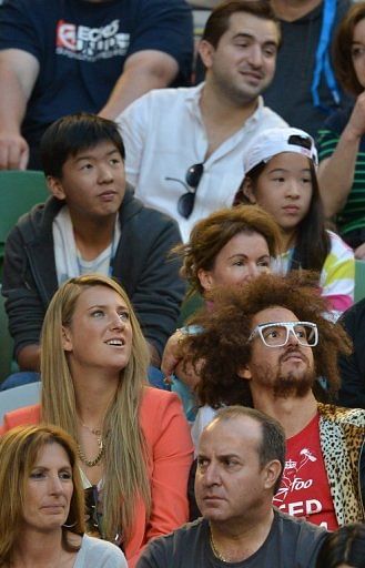 Women's Singles Champion Belarus's Victoria Azarenka watches Serbia's Novak Djokovic in Melbourne on January 27, 2013