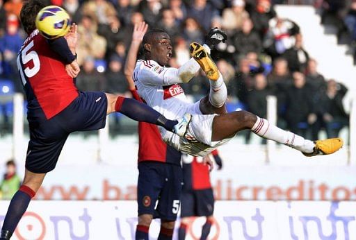 AC Milan&#039;s Mario Balotelli (R) kicks the ball past Cagliari&#039;s Luca Rossettini (L) in Cagliari on February 10, 2013