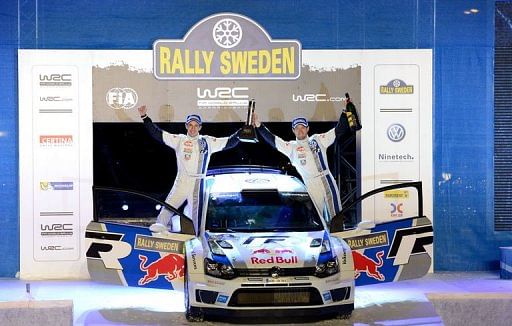 Sebastien Ogier (R) and co-driver Julien Ingrassia celebrate on their car in Karlstad on February 10, 2013