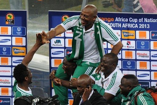 Nigeria&#039;s head coach Stephen Keshi (C) is carried by staff members on February 10, 2013 at Soccer City stadium