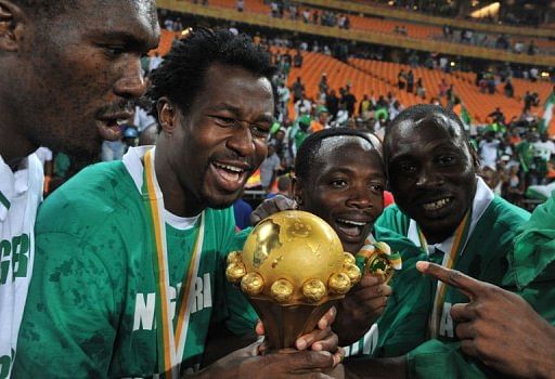 Nigeria&#039;s players hold the trophy as they celebrate on February 10, 2013 at Soccer City stadium in Johannesburg