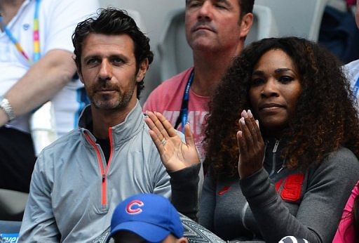 Serena Williams claps next to coach Patrick Mouratoglou at the Australian Open in Melbourne on January 14, 2013
