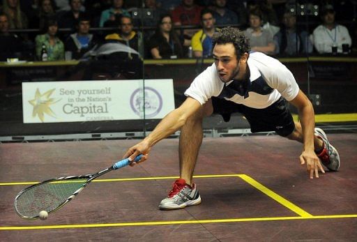 Ramy Ashour of Egypt hits a return against Omar Mosaad in the Australian Open squash men&#039;s final on August 19, 2012