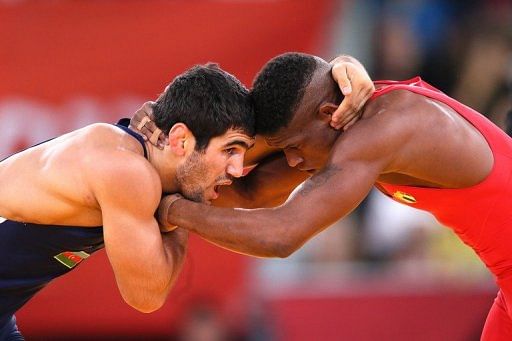 Cuba&#039;s Livan Lopez Azcuy (right) wrestles Azerbaijan&#039;s Jabrayil Hasanov in their men&#039;s 66kg bronze Olympic medal match