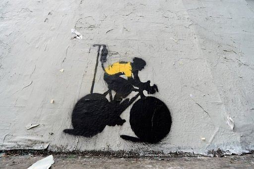 A stencil depicting Lance Armstrong in a yellow jersey attached to an IV drip, in Los Angeles on January 23, 2013