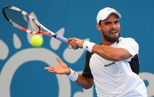 Alejandro Falla hits a forehand return during his match against Gilles Simon on January 2, 2013