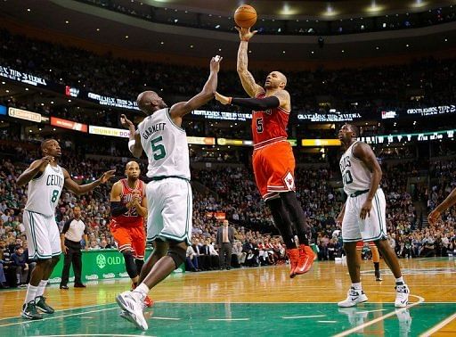 Carlos Boozer of the Chicago Bulls takes a shot over Kevin Garnett of the Boston Celtics, on February 13, 2013