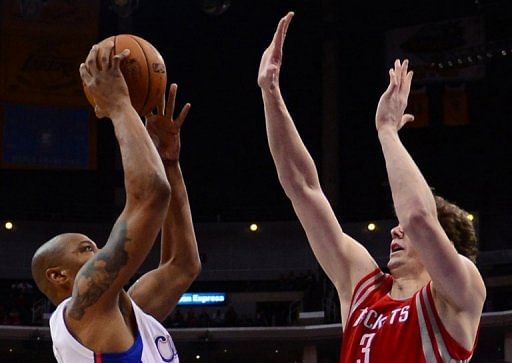 Caron Butler (L) of the LA Clippers shoots against Omer Asik of the Houston Rockets, on February 13, 2013