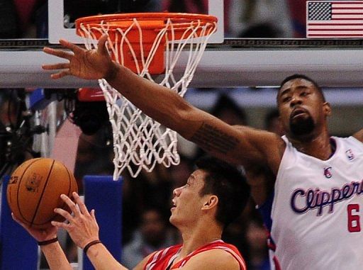 Jeremy Lin of the Houston Rockets (L) shoots against DeAndre Jordan of  the LA Clippers, on February 13, 2013